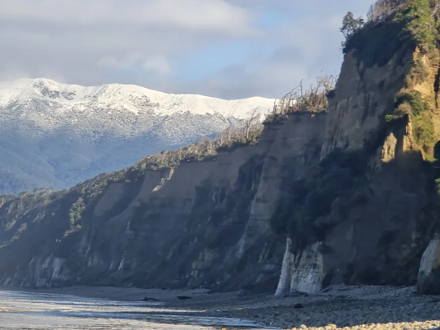 The cliffs up close, snow on the tops beyond