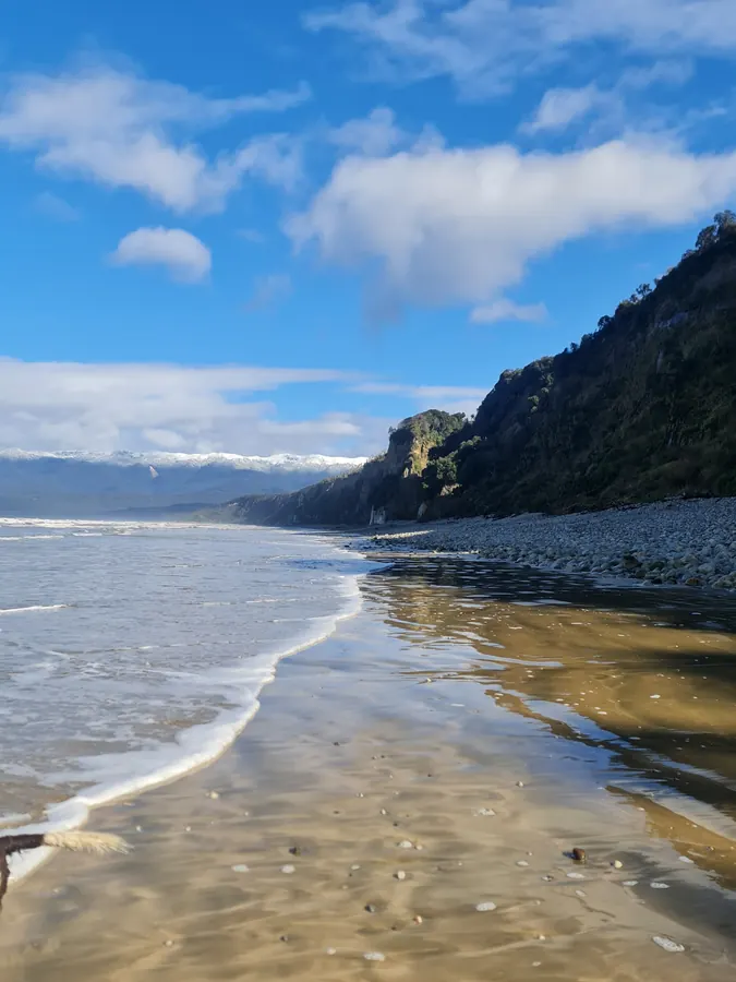 Foam lines on the sand as the tide comes in