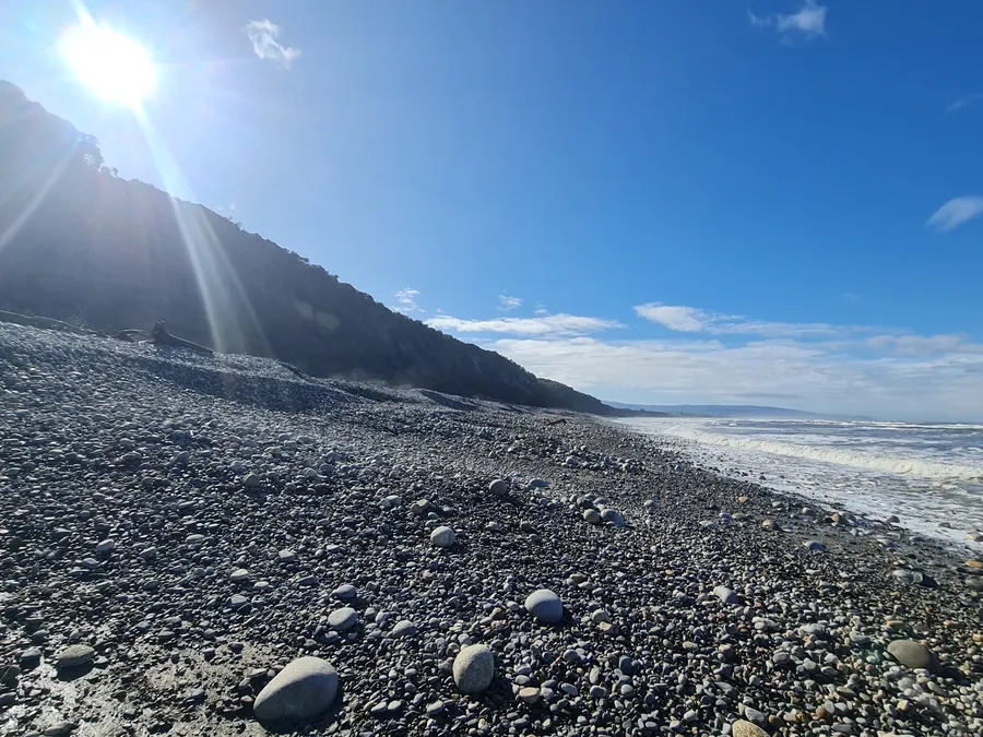 Morning sun over the stony shore