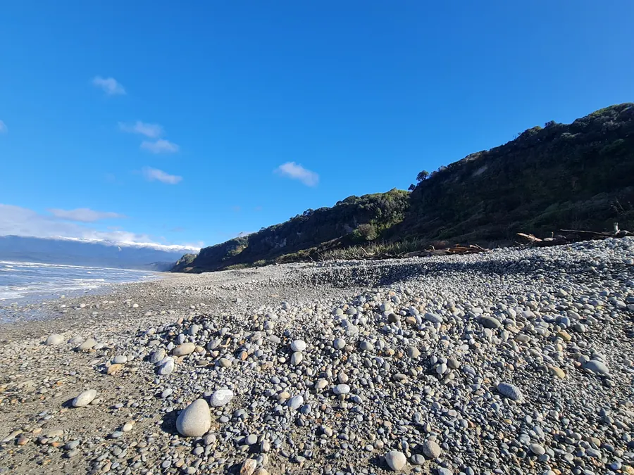 Pebbles and a bush-clad headland