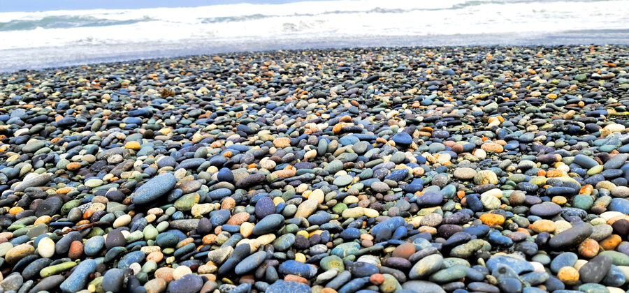 Waves rolling onto the pebble shoreline at Gemstone Beach