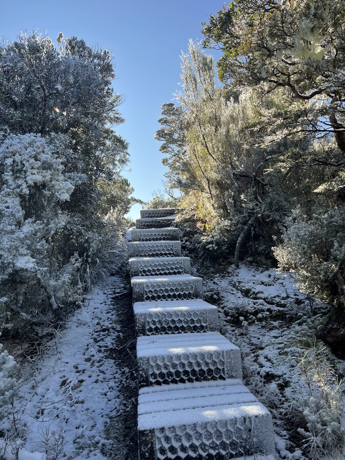 Fresh snow on the track's timber steps