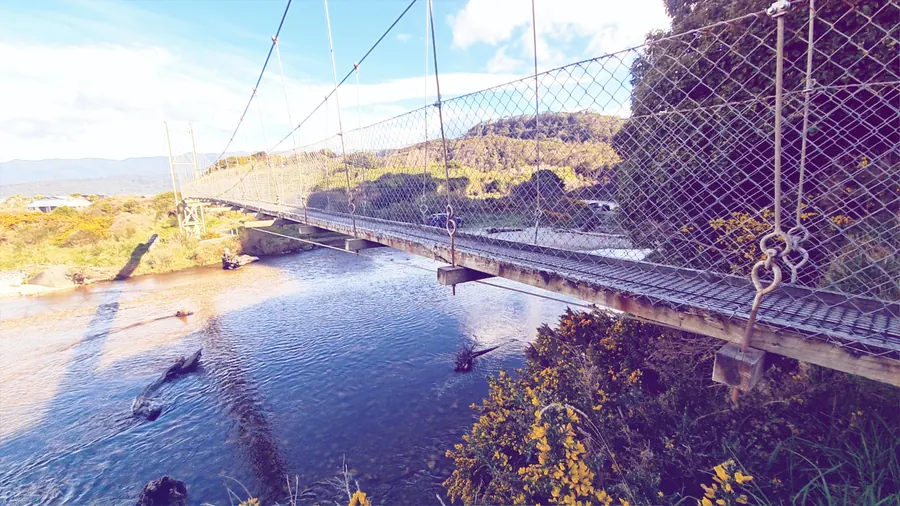 Cables and mesh of the swingbridge above the river
