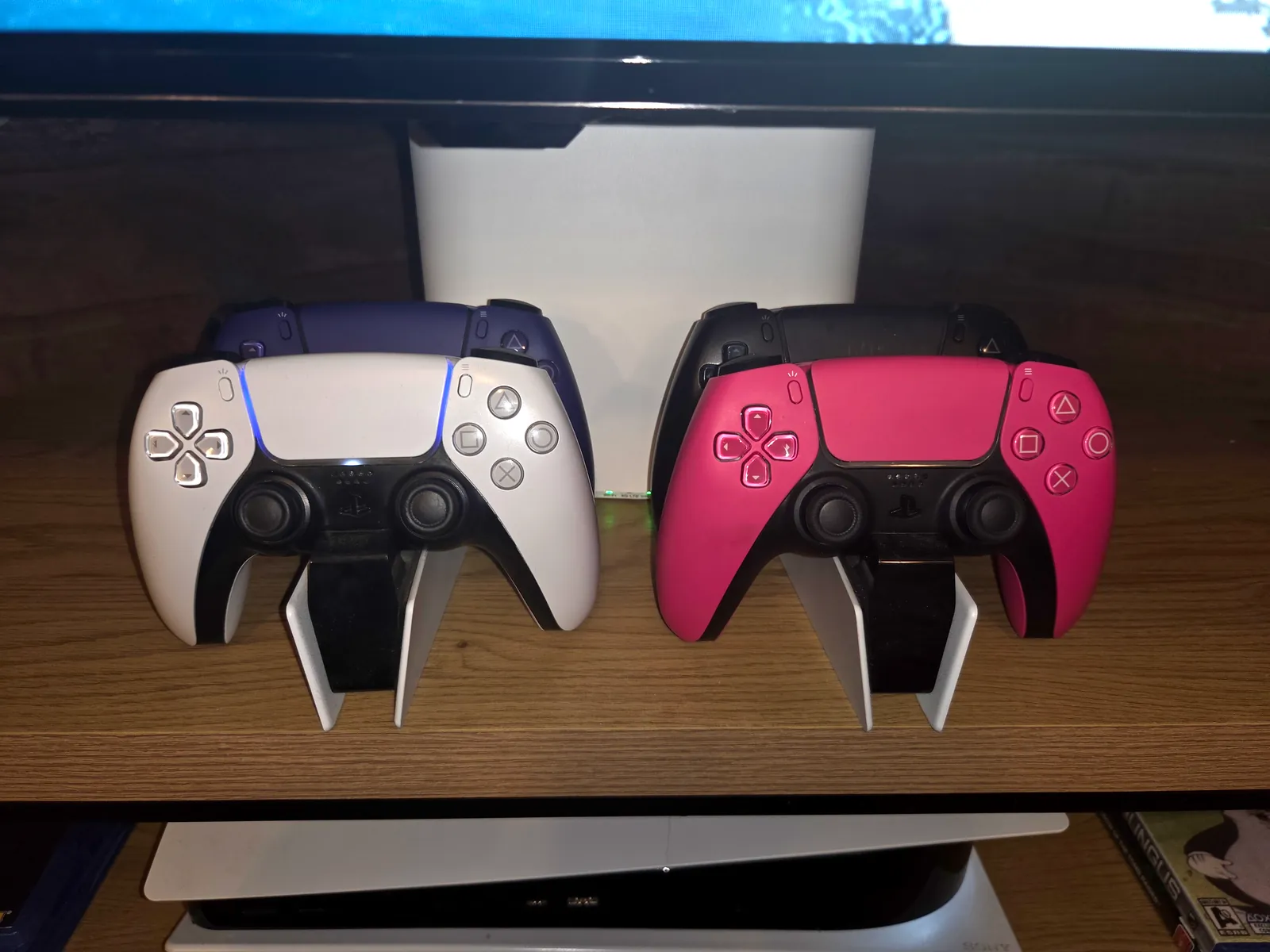 Four PS5 controllers on their charging stands